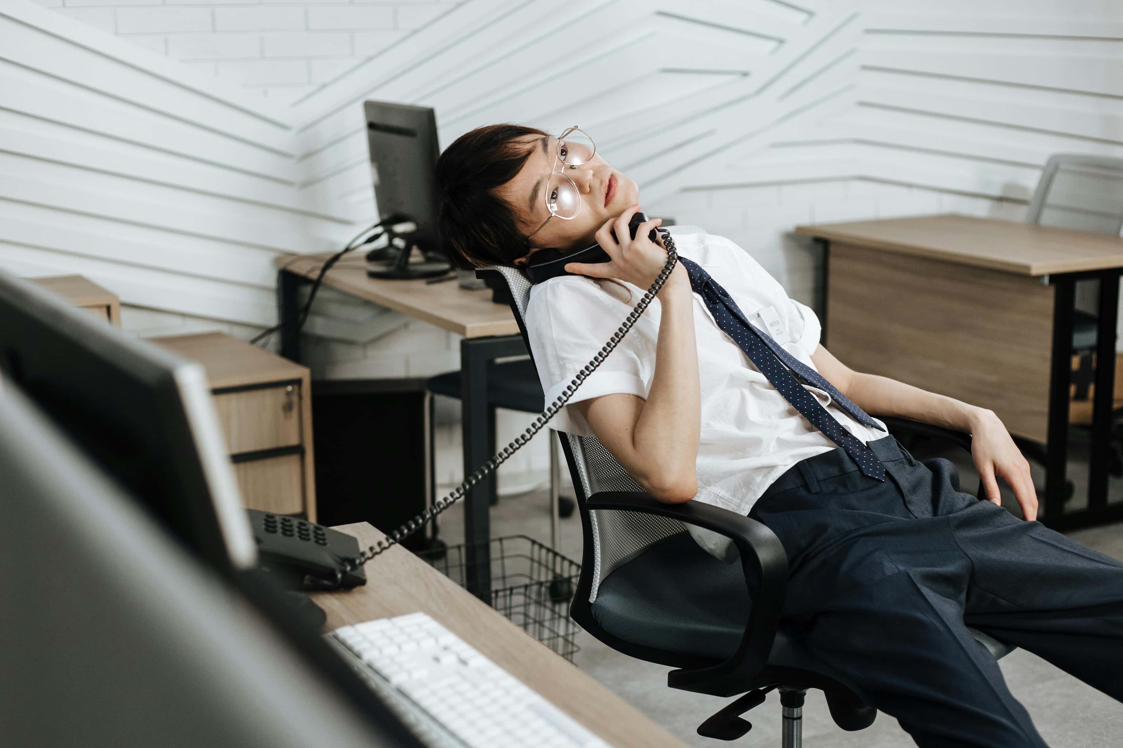 Tired call handler dealing with too many ringing lines